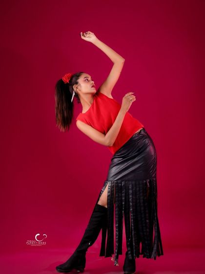 A graceful and powerful pose with an arm raised. The composition is elegant and full of movement.