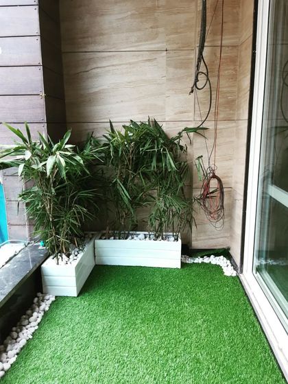 This view shows how we work around existing structures, like the pillar, to create a seamless green floor for the balcony.