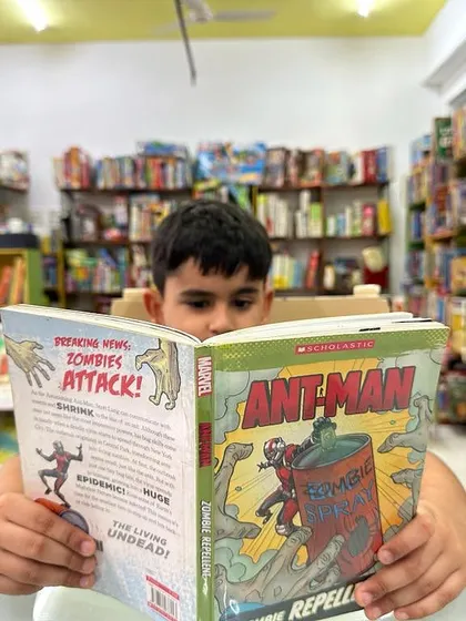 This is the ultimate goal: a child completely lost in the world of a book. In our library, we create a cozy and encouraging environment where children can explore thousands of titles and find stories that speak directly to them, fostering a lifelong love for reading.