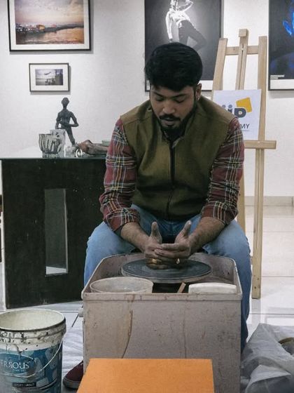 A guest artist giving a wheel-throwing demonstration during a workshop. It's inspiring for students to see different artists and their techniques.