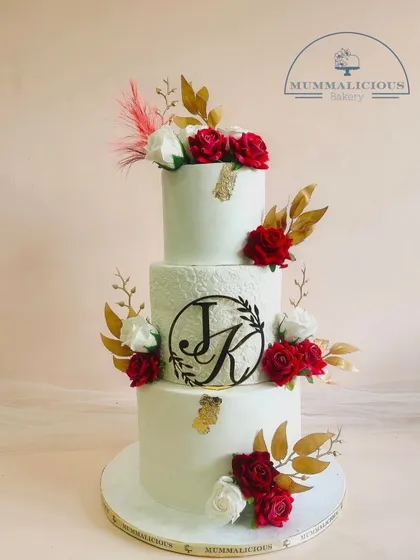 This is where elegance meets love. Our three-tiered wedding cake, personalized with the couple's initials and adorned with handcrafted red and white sugar roses, is designed to be the stunning centerpiece of your special day.