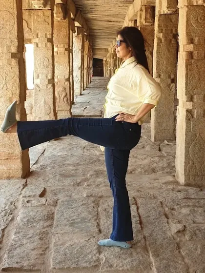 A standing leg raise in a historic setting. Yoga helps us find focus and stability even when surrounded by distractions. It is a powerful tool for cultivating balance, both physically and mentally.