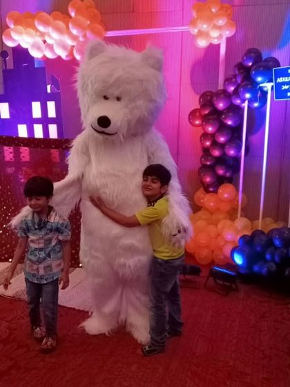Kids giving my giant fluffy Teddy Bear a big hug. This character is always a huge hit, especially with younger children, and adds a soft, friendly touch to the party.