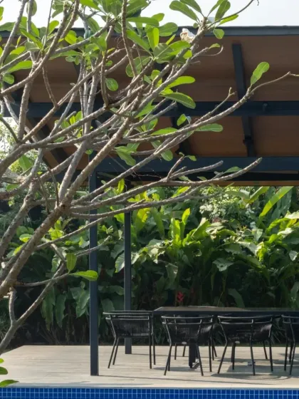 An outdoor dining pavilion by the pool in Alibaug. These spaces are central to our philosophy of creating homes that encourage living in harmony with nature.