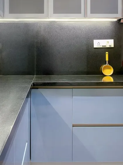 This blue and black kitchen at Embassy Lake Terraces was designed for people who love to cook but hate to clean. The glossy cabinetry wipes clean in seconds, and the polished granite resists stains.