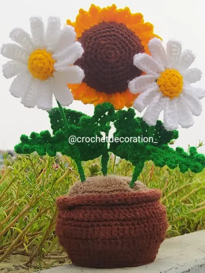 This custom potted arrangement combines a cheerful crochet sunflower with two delicate white daisies. It shows how we can mix and match different flowers in a single pot to create a unique piece for your desk or home.