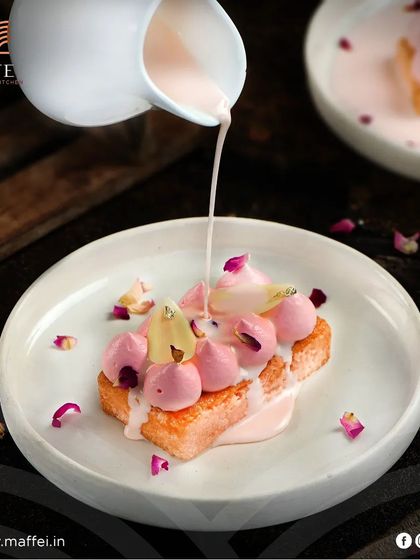 Our Tres Leches Cake, a soft sponge cake soaked in three kinds of milk and topped with a delicate rose-flavored cream and petals. It's a light yet decadent dessert.