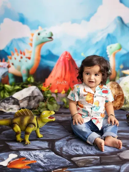 A sweet, happy moment surrounded by friendly dinosaurs. His dinosaur-print shirt completes the theme perfectly.