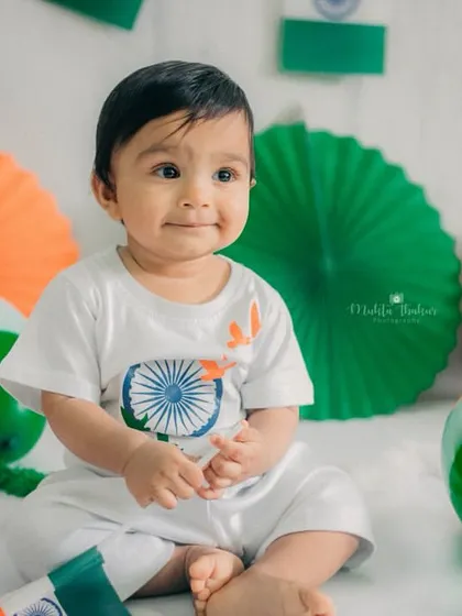A sweet, calm moment amidst the celebration. He looks so adorable in his tricolor-themed outfit.