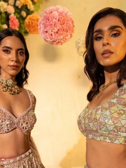 A close-up on two of the models, showing the different blouse designs and jewellery pairings.