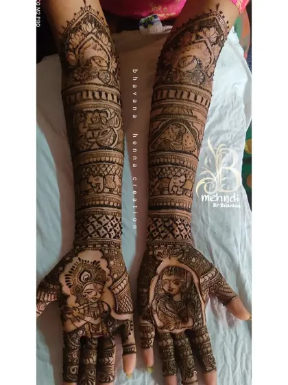 For a touch of divine love, I often create Radha-Krishna portraits. This design combines the classic spiritual motif with intricate patterns and traditional elements like elephants, covering the full arm for a complete bridal look.