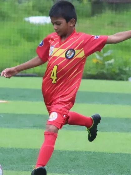 A young U9 player takes a shot on goal during the tournament.
