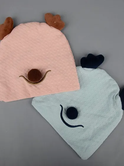 Two adorable hooded towels for babies, one pink and one blue, with cute animal faces.
