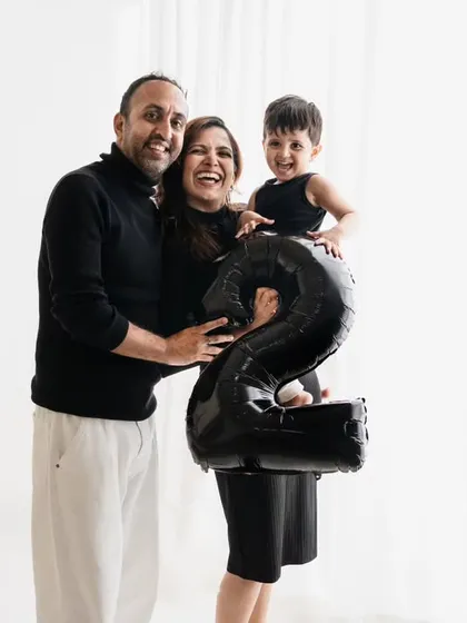 Celebrating a second birthday together! Using a number balloon is a fun way to mark the milestone, and this family's joy is absolutely infectious.