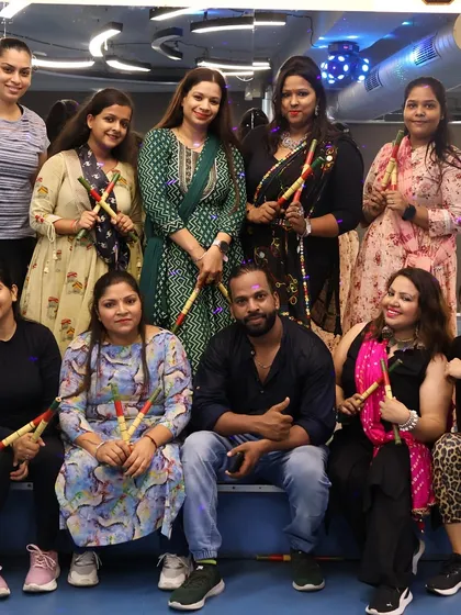 Our members and I posing with dandiya sticks during our Navratri event.