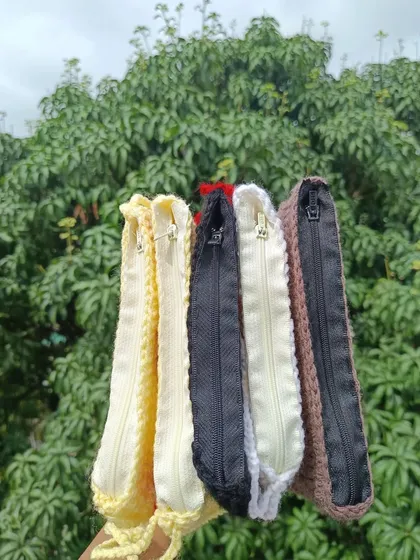 Showing the inside of my crochet pouches, which are lined and feature a secure zipper closure to keep belongings safe.