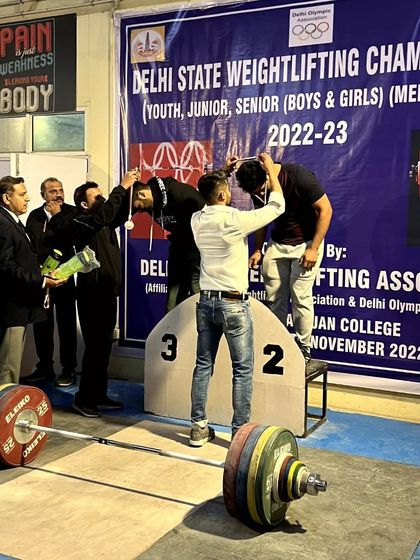 A proud moment, presenting a medal to a winning athlete at the Delhi State Weightlifting Championship. Seeing lifters achieve their goals is what makes coaching so rewarding.