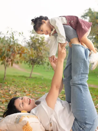 A playful 'airplane' pose with mom. These are the fun memories that you'll look back on and smile.