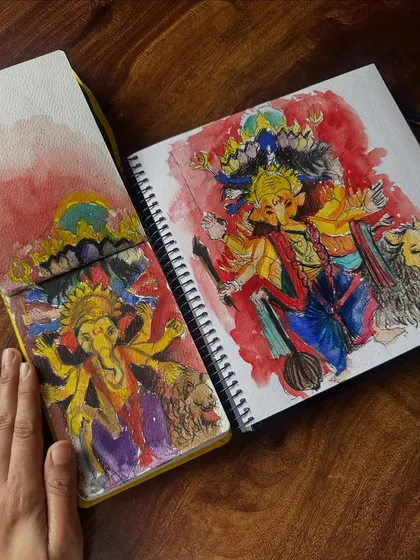 Two of my sketchbooks side-by-side, both featuring watercolour tributes to Ganpati Bappa. Each painting offers a different interpretation and style, showing my love for the subject.