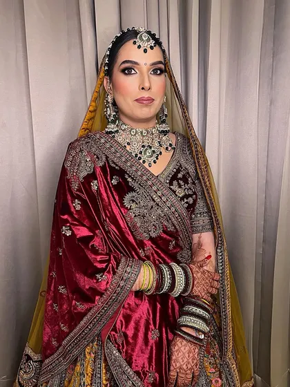 A full view of this sweet bride in her bridal glory. The makeup is designed to be both elegant and long-lasting, perfect for a winter wedding.