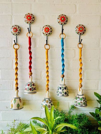 A vibrant set of five macrame ceramic bells in different colors. These are one of our best-selling products, and you can customize the colors to create your own unique set.
