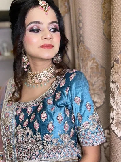 A beautiful client all dolled up for her brother's reception. The teal and pink lehenga is paired with soft, shimmery eye makeup.