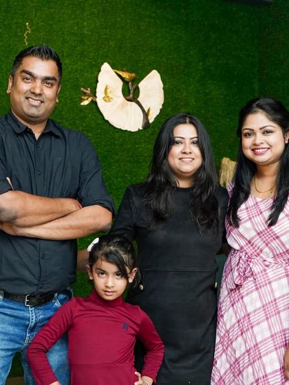 A family with their young daughter enjoying an evening out. It's a place where memories are made for everyone.