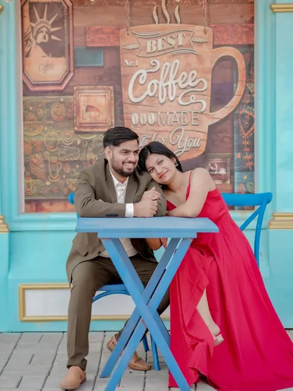 A cozy and romantic moment at a cafe-themed set. The couple's intimate pose and the charming background create a sweet, story-driven image perfect for their pre-wedding album.