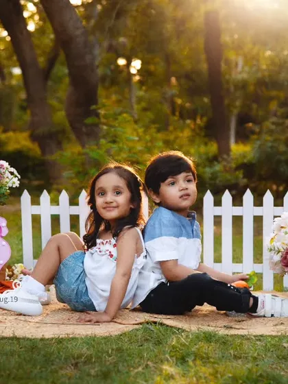 The bond between siblings is so special. We captured this beautiful, candid moment during an outdoor picnic-themed session, filled with sunshine and laughter.