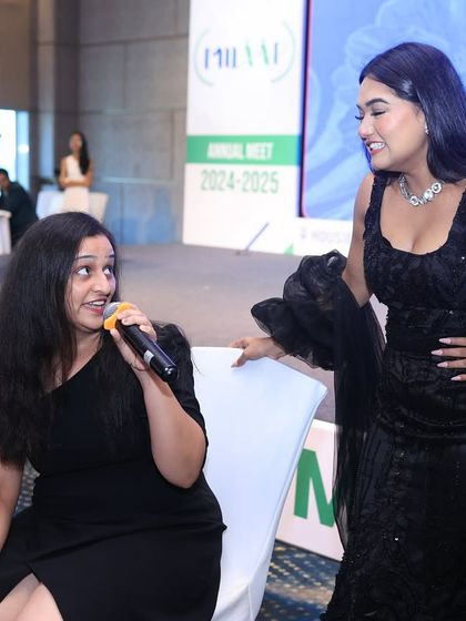 Sharing a laugh with a participant on stage. My approach is always friendly and relatable, making people feel comfortable and eager to join in.