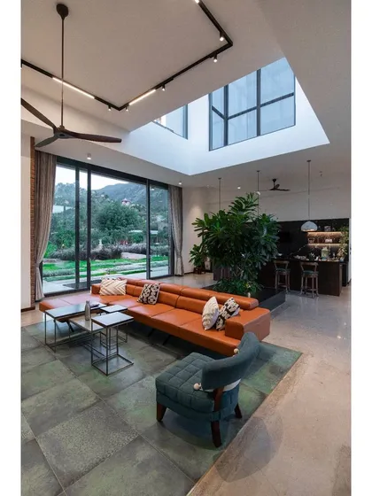 The living space of the Weekend Home at Nandi Hills, designed to bring in the maximum amount of natural light. The layout creates a seamless experience from the outdoors into the house, perfect for entertaining.