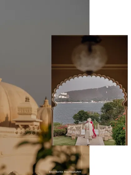 A creative composition showing the couple walking by the lake, framed within the beautiful architecture of their Udaipur palace venue.