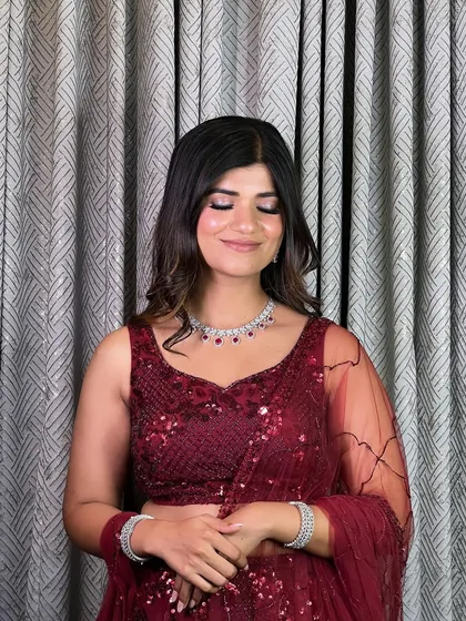 Eyes closed to showcase the soft smokey eye and luminous skin. This look is a perfect example of how to do glam in a modern, elegant way.