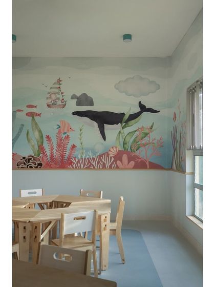 Another beautiful scene from the aqua classroom's wallpaper, featuring a large whale and a pirate ship. These imaginative details turn the classroom walls into a storybook.