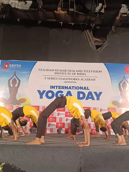 My students performing a synchronized group backbend during an International Yoga Day celebration. This pose, Chakrasana, requires immense flexibility and coordination, which we build step by step.