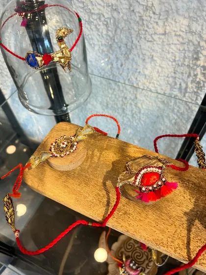 Bold colors, intricate details, endless love. My collection of designer rakhis, like these featuring tassels and stone work, go beyond the ordinary.