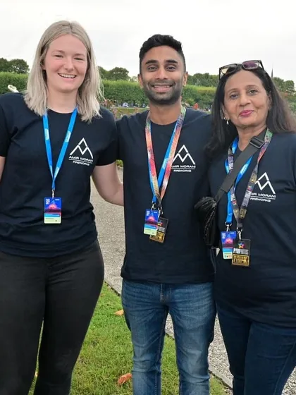 The team proudly wearing their custom T-shirts at an international event, representing their brand.