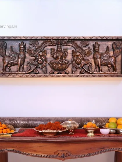 The same Mahalakshmi and Kamadhenu panel, shown in a different context with offerings. This highlights its function as a central element in festive or daily rituals.