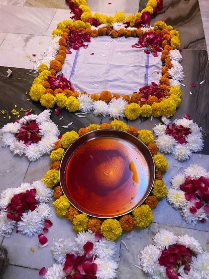 A close-up of the central part of the welcome arrangement, where the thali is placed. I use a combination of yellow marigolds, white chrysanthemums, and red rose petals for a vibrant look.