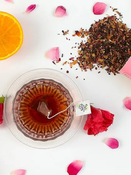 A top-down flat lay is a powerful format for social media and websites. Here, we arranged a brand's rose and lemon tea with its core ingredients and packaging, creating a visually clean and informative shot that tells a story of flavor and quality.