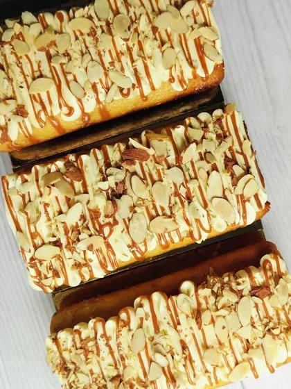 A truly decadent option, my Butterscotch, Caramel, and Almond Tea Cakes are infused with crunchy butterscotch nuts and roasted almonds, then topped with buttercream and a caramel drizzle.