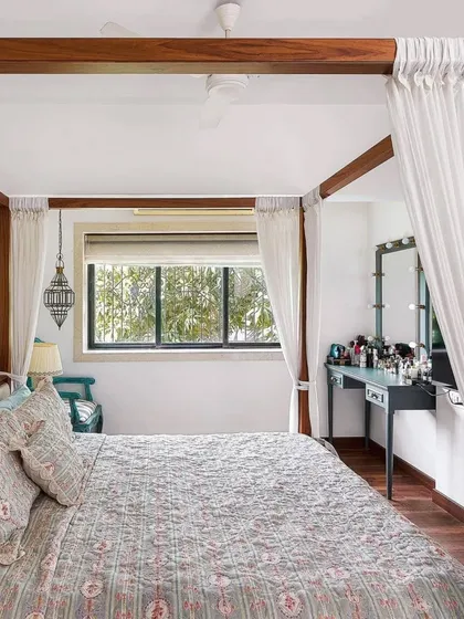 For Aditi Rao Hydari's home, the bedroom is a serene escape. A four-poster bed with light, airy curtains creates a dreamy focal point. The space is kept simple and elegant, with a focus on comfort and tranquility.