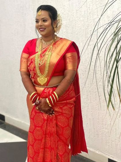 The bride looks stunning in her red muhurtham saree. By pre-pleating the saree, we ensured her look was flawless and ready on time for the main ceremony.