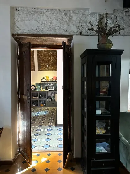 Another glimpse of the afternoon sun casting its glow on the floor, highlighting the texture of the restored walls and the dark wood of the cabinet. These moments of natural beauty are what make a space feel alive.
