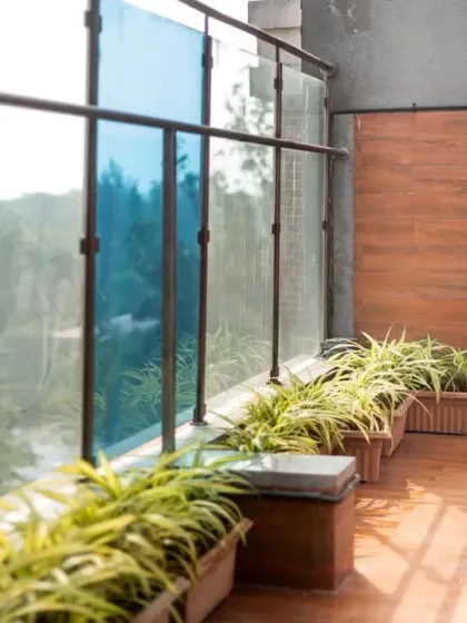 A portrait of the groom, waiting with anticipation on a balcony overlooking a beautiful landscape.
