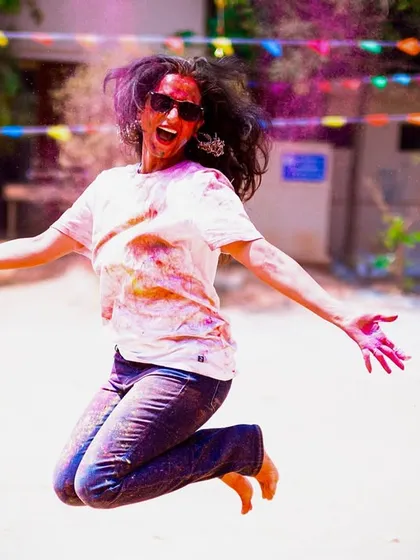 Jumping for joy during our Holi celebration. My classes are more than just a workout; they are a reason to celebrate life, get a little messy, and make unforgettable memories.