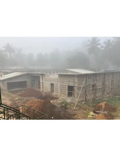 An early morning view of the site shrouded in fog. This image captures the building taking shape and settling into its environment, even before completion.