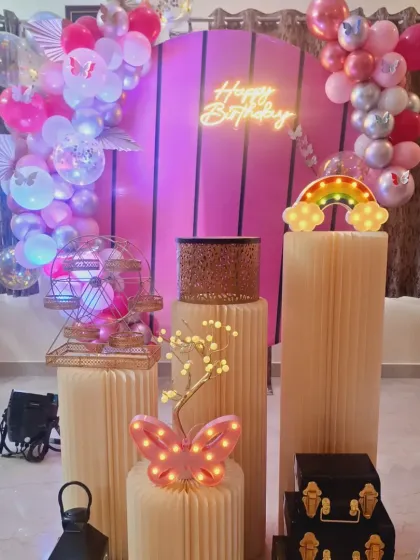 The lighting highlights the beautiful details of this butterfly party, including the clear balloons with butterfly confetti inside.