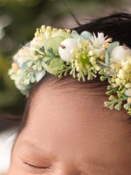 A detailed shot of a beautiful floral headband on a baby's head. I use high quality, soft accessories that are perfectly sized for newborns.