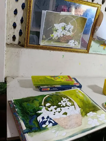 A watercolor still life of a basket of flowers in progress. This image captures the initial washes of color being laid down.